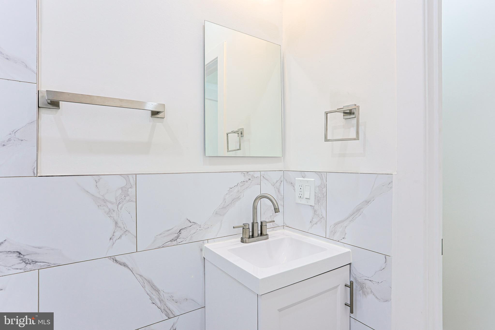 5520 Pemberton Street Philadelphia, PA 19143 - Photo 16 of 28 a bathroom with a sink and a mirror