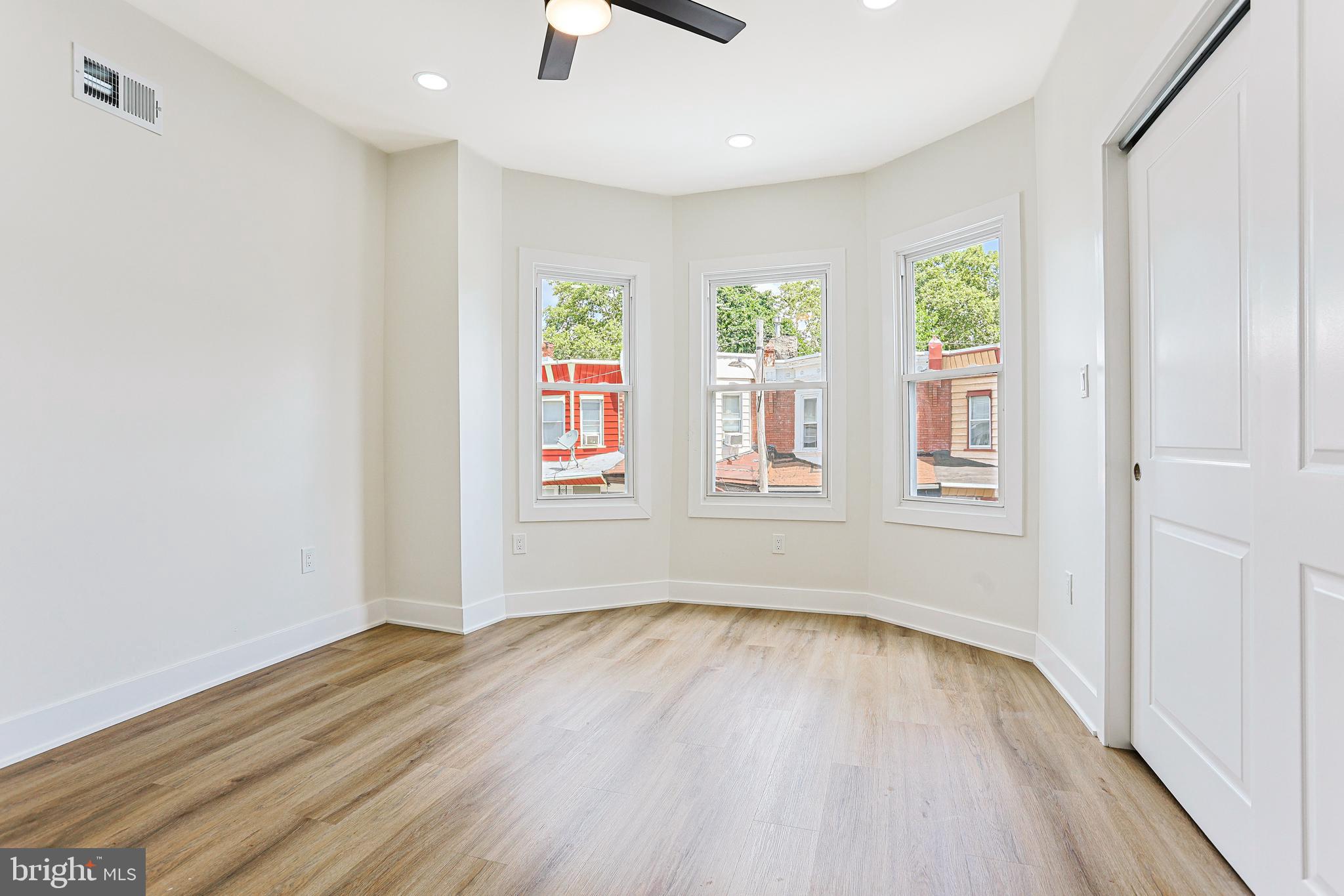 5520 Pemberton Street Philadelphia, PA 19143 - Photo 20 of 28 an empty room with wooden floor and windows