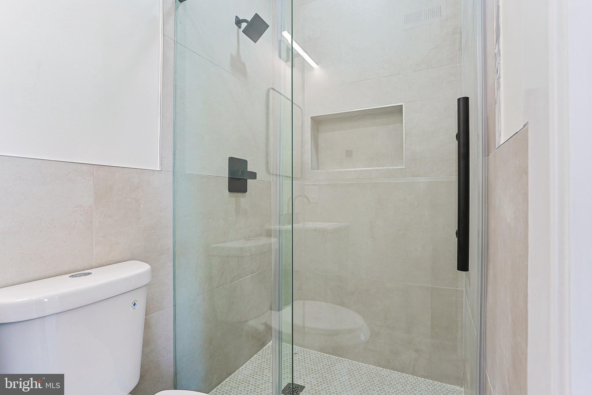 5520 Pemberton Street Philadelphia, PA 19143 - Photo 23 of 28 a bathroom with a shower and toilet