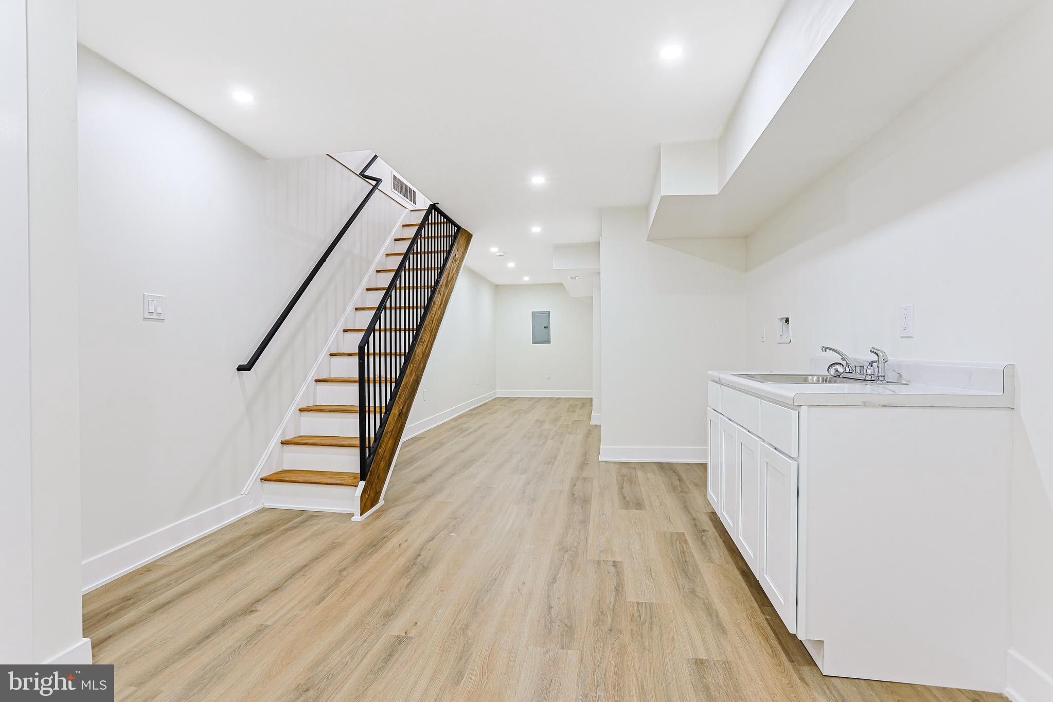 5520 Pemberton Street Philadelphia, PA 19143 - Photo 25 of 28 a view of a hallway with wooden floor and staircase