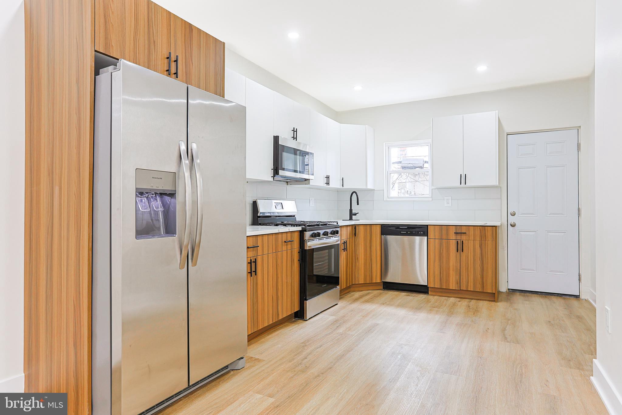 5520 Pemberton Street Philadelphia, PA 19143 - Photo 4 of 28 a kitchen with stainless steel appliances a refrigerator and a stove top oven