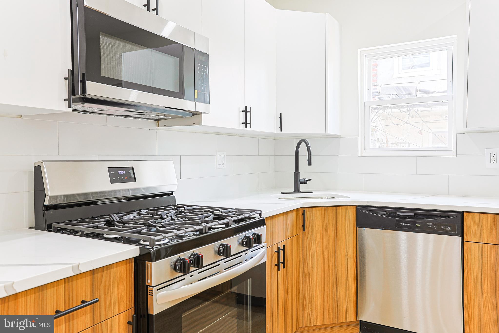 5520 Pemberton Street Philadelphia, PA 19143 - Photo 6 of 28 a kitchen with a stove and a microwave