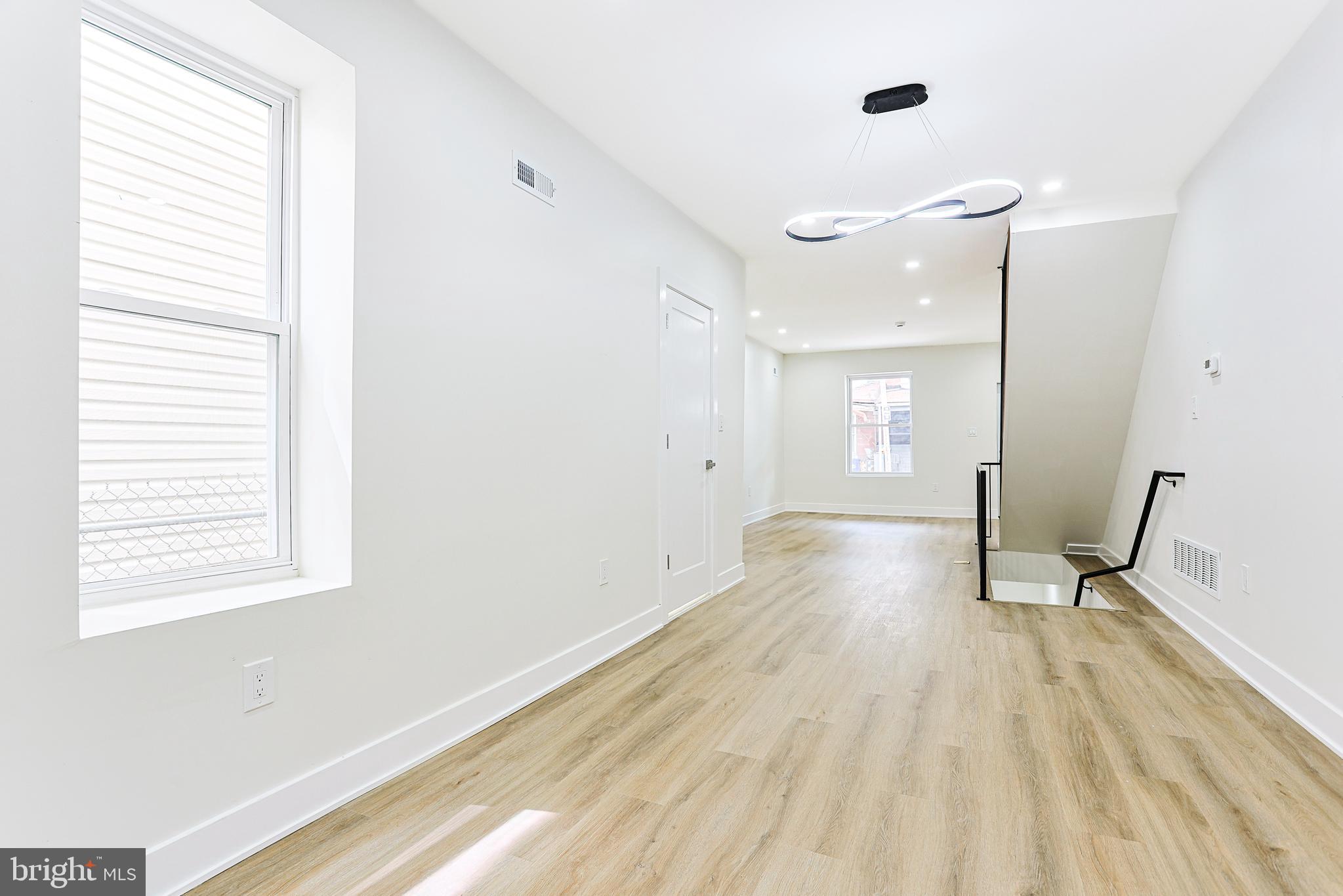 5520 Pemberton Street Philadelphia, PA 19143 - Photo 10 of 28 a view of a room with wooden floor and windows
