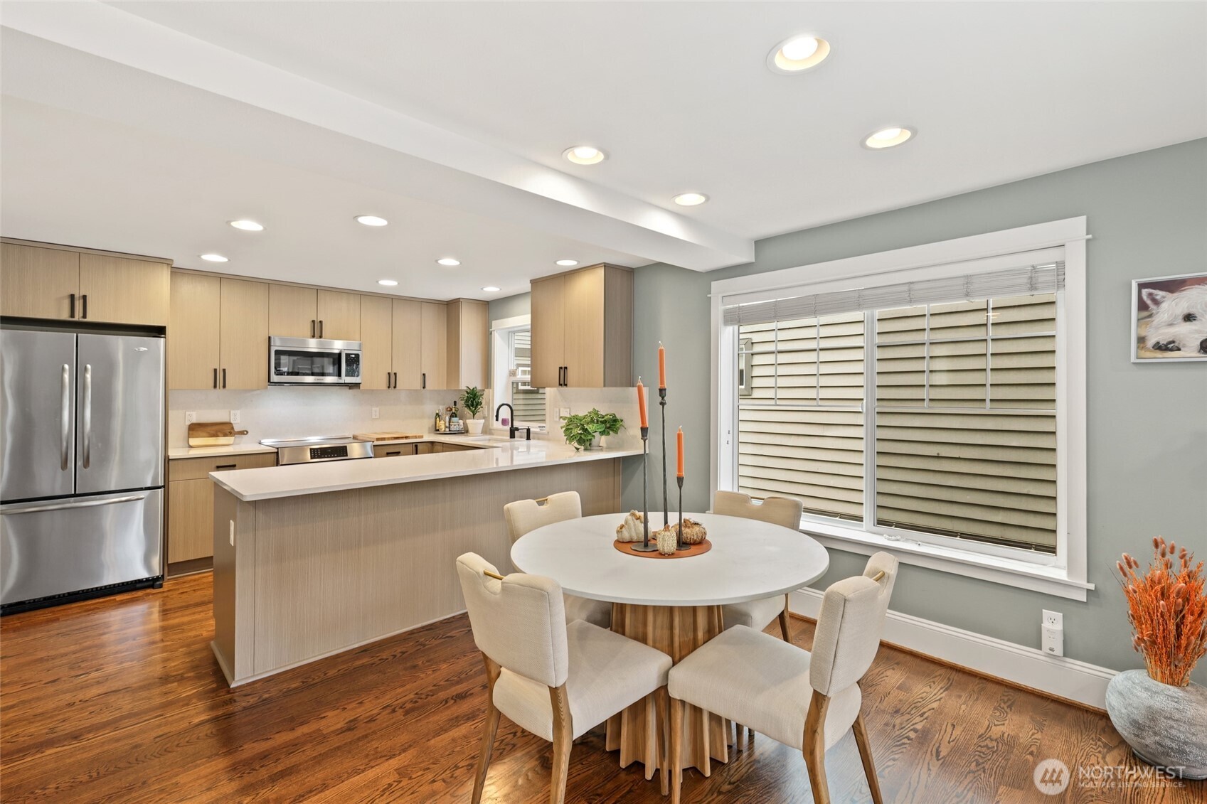 4535 Northeast 55th Street Seattle, WA 98105 - Photo 13 of 27 a kitchen with a dining table chairs and refrigerator