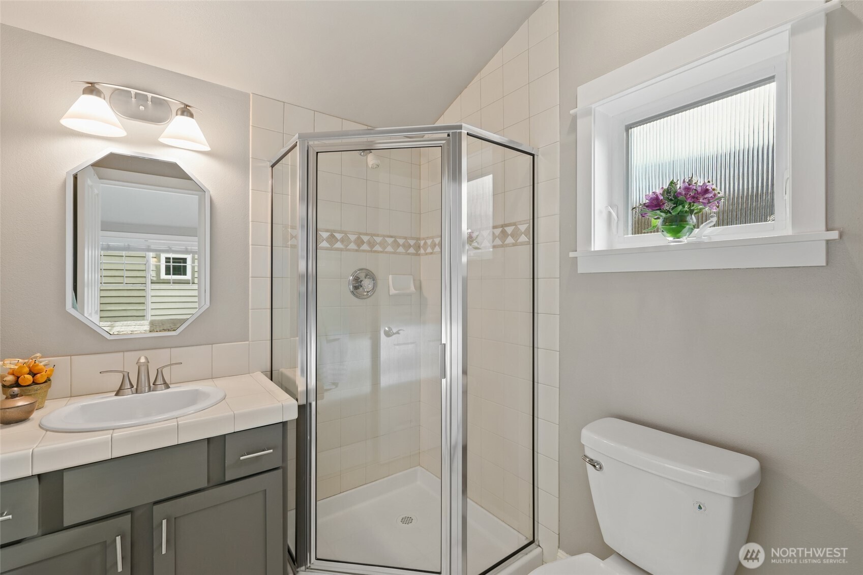 4535 Northeast 55th Street Seattle, WA 98105 - Photo 4 of 27 a bathroom with a granite countertop sink toilet and shower