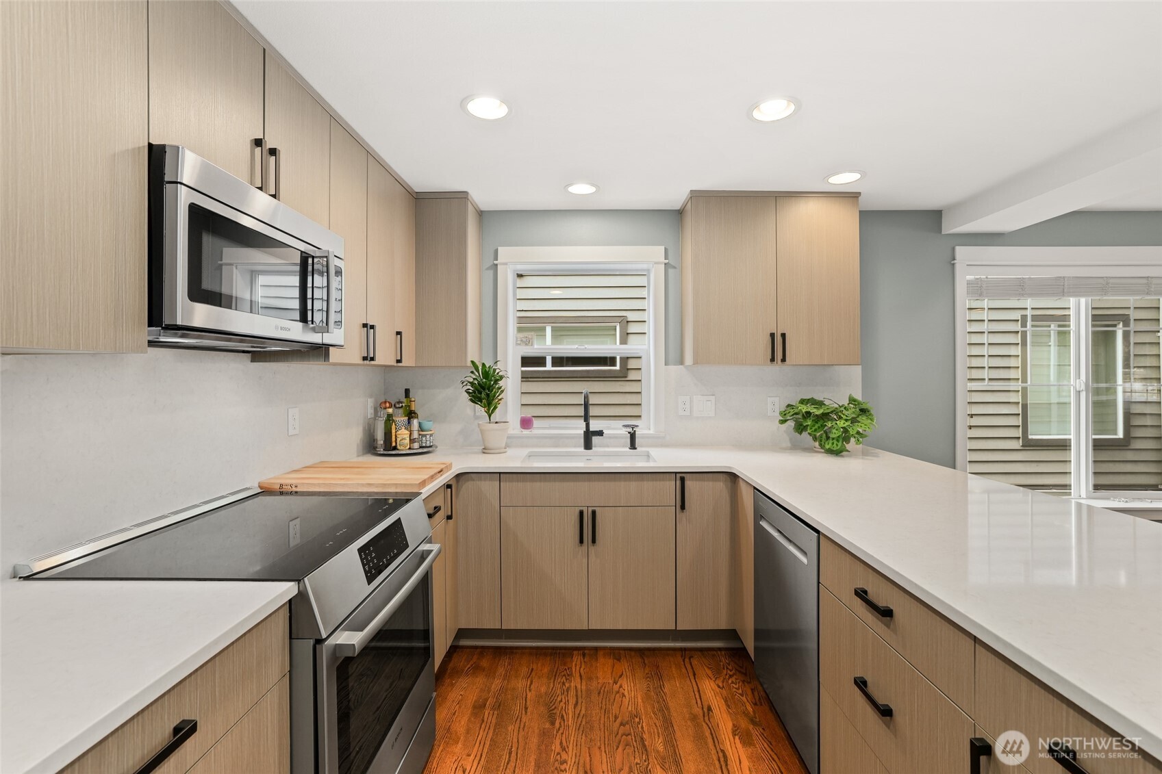 4535 Northeast 55th Street Seattle, WA 98105 - Photo 10 of 27 a kitchen with a sink stove and cabinets