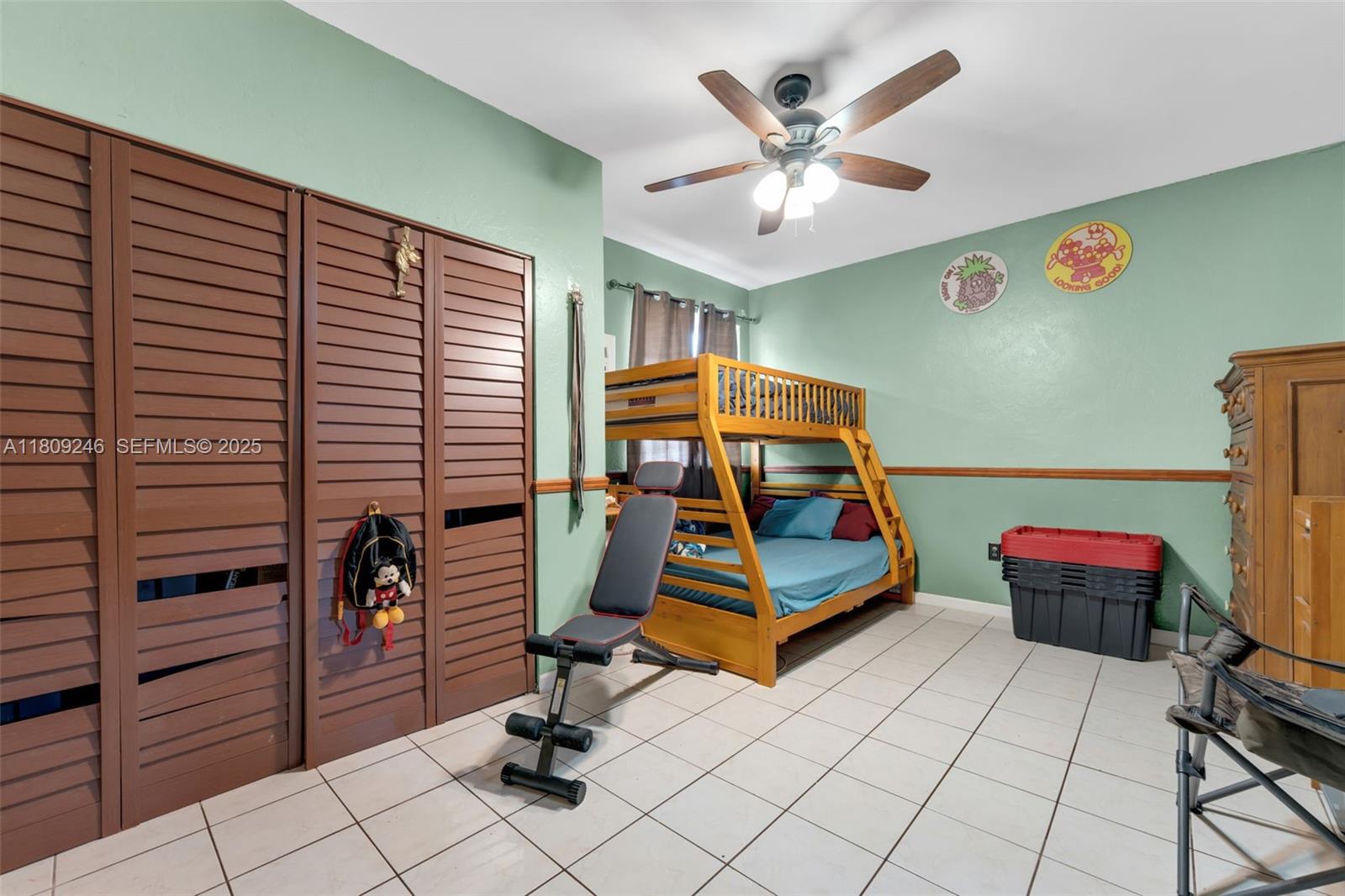 10813 Southwest 158th Lane Miami, FL 33157 - Photo 11 of 27 a bedroom with a bed and a chandelier