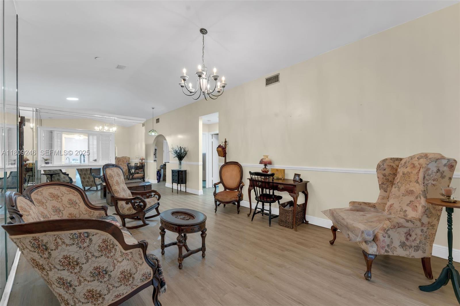 10813 Southwest 158th Lane Miami, FL 33157 - Photo 27 of 27 a living room with furniture a chandelier and a rug