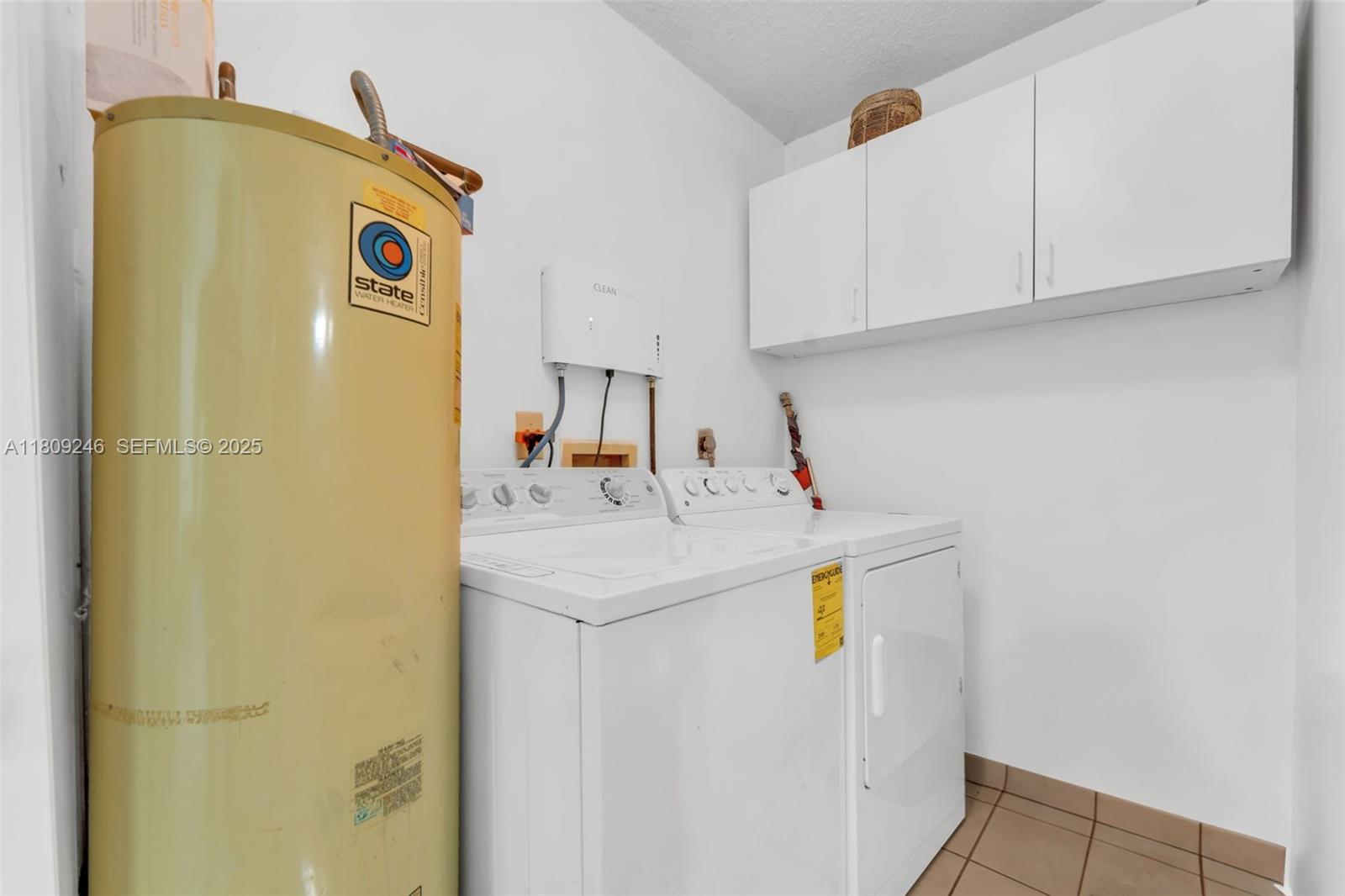 10813 Southwest 158th Lane Miami, FL 33157 - Photo 9 of 27 a utility room with a sink a washer and dryer