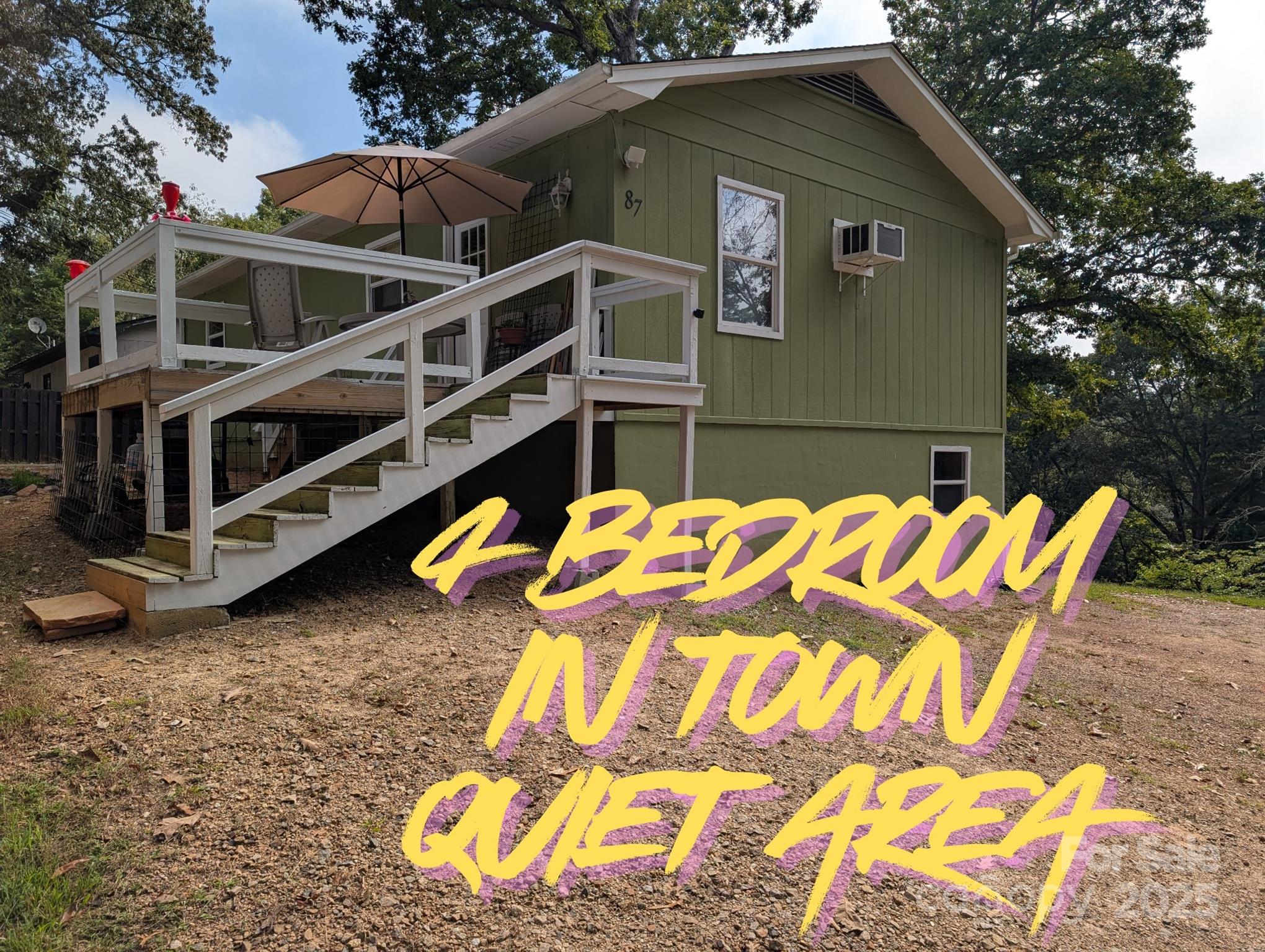 a backyard of a house with wooden fence and deck