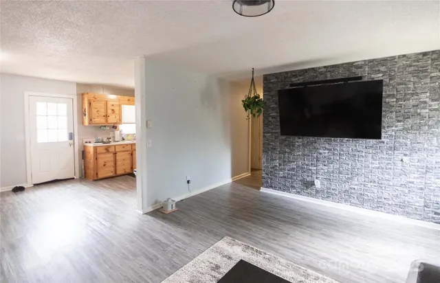 a view of a livingroom with furniture and an empty room