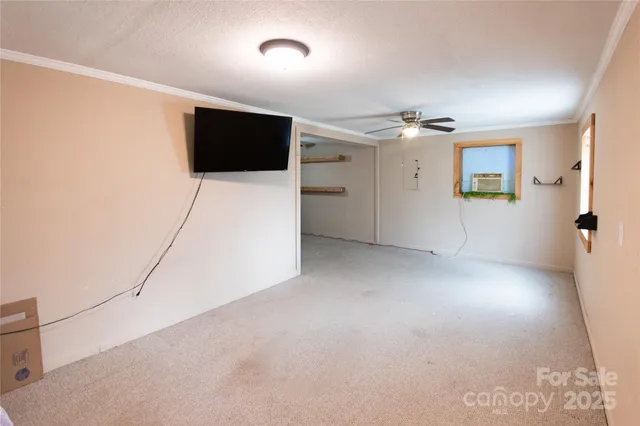 a view of a livingroom with furniture and a flat screen tv