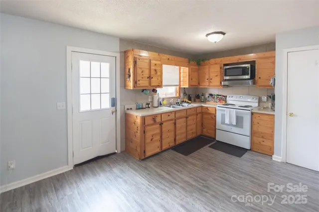 a kitchen with stainless steel appliances granite countertop a sink and window