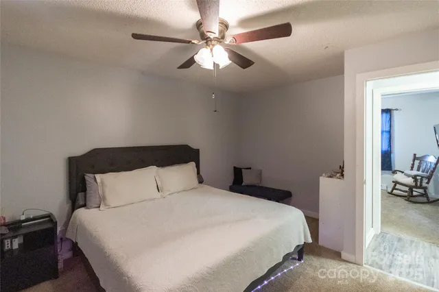 a bedroom with a bed and a view of bedroom