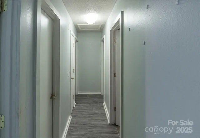 a view of hallway with wooden floor