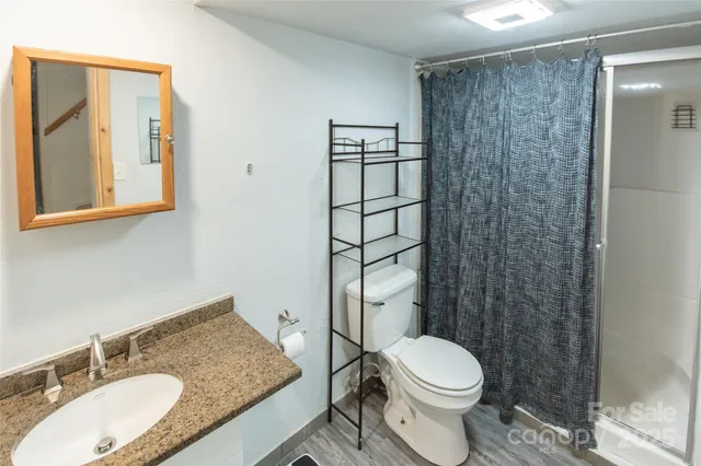 a en suite bathroom with a sink a mirror and shower