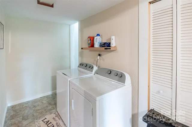 a view of bathroom with a shower and a sink