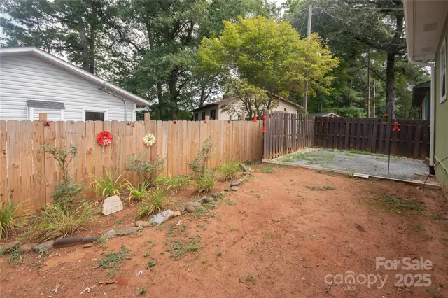 a backyard of a house with table and chairs