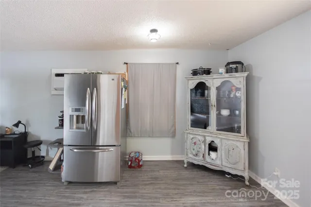 a kitchen with stainless steel appliances a refrigerator and microwave