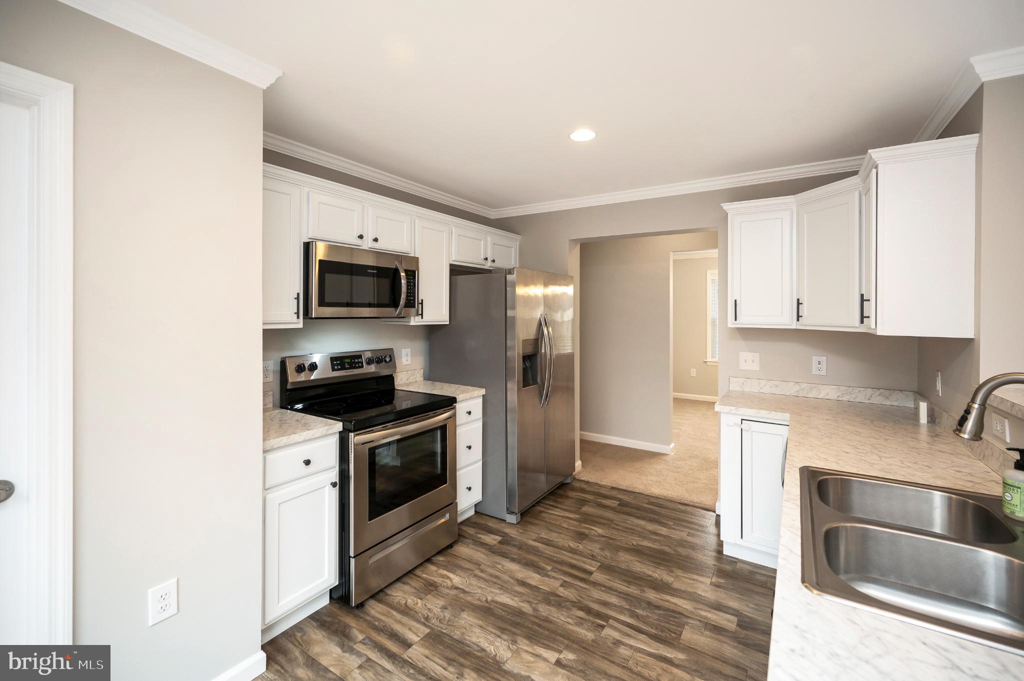 6112 Eds Road Mineral, VA 23117 - Photo 7 of 39 a kitchen with a stove top oven and refrigerator