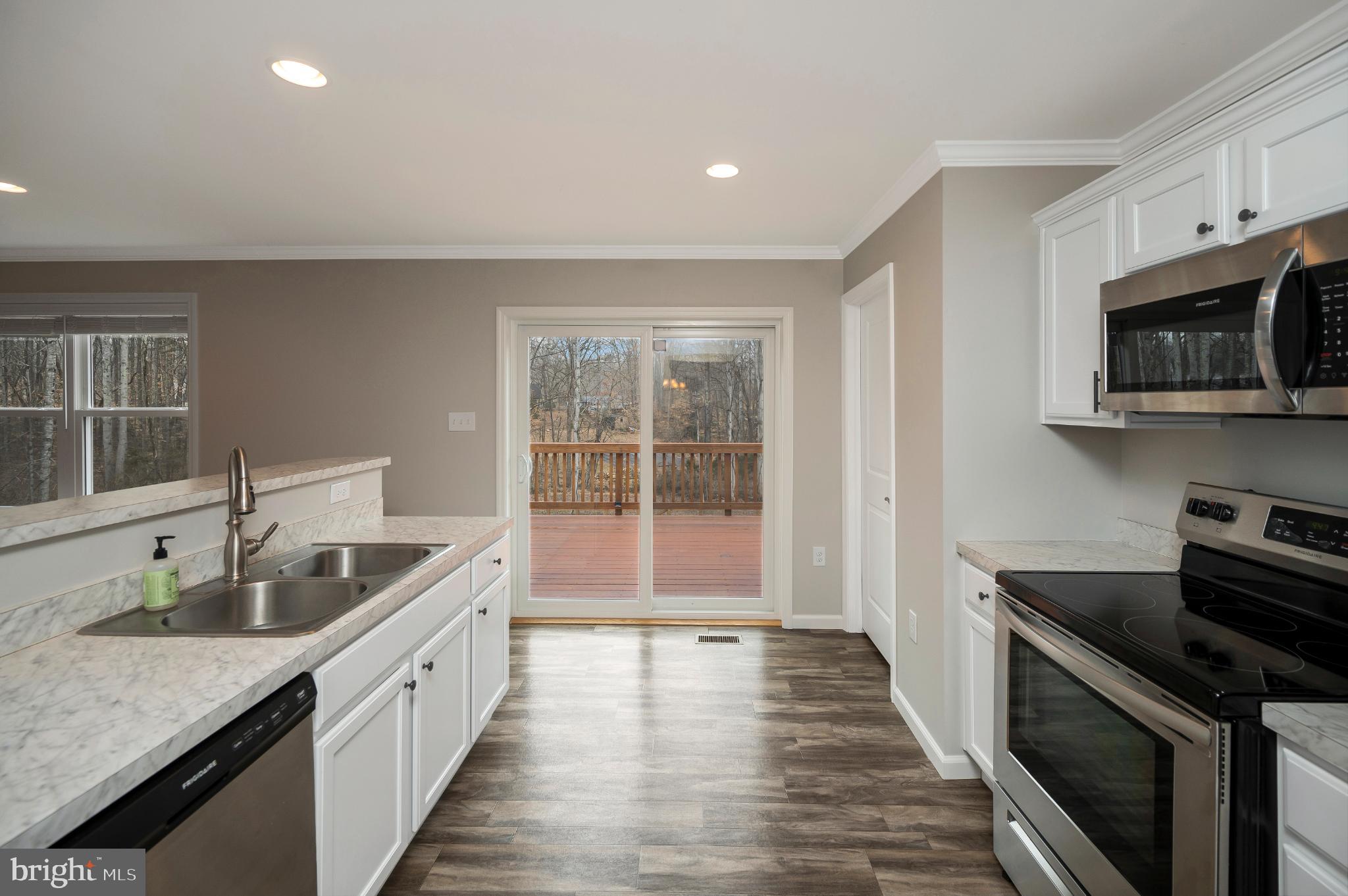 6112 Eds Road Mineral, VA 23117 - Photo 10 of 39 a kitchen with granite countertop a sink and a stove top oven