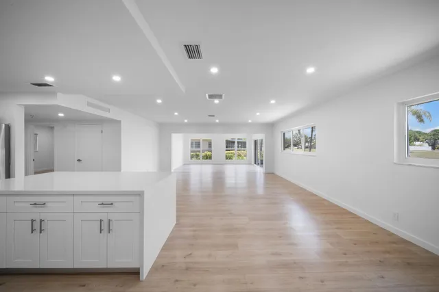a view of kitchen with kitchen island and stainless steel appliances