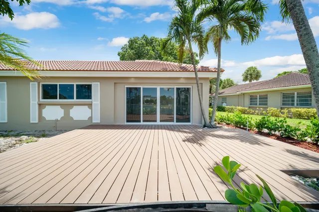an aerial view of a house with a yard and lake view