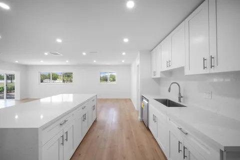 a large kitchen with a large counter top appliances and cabinets