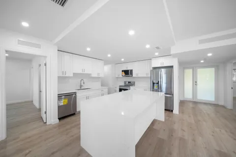 a view of kitchen with center island and wooden floor