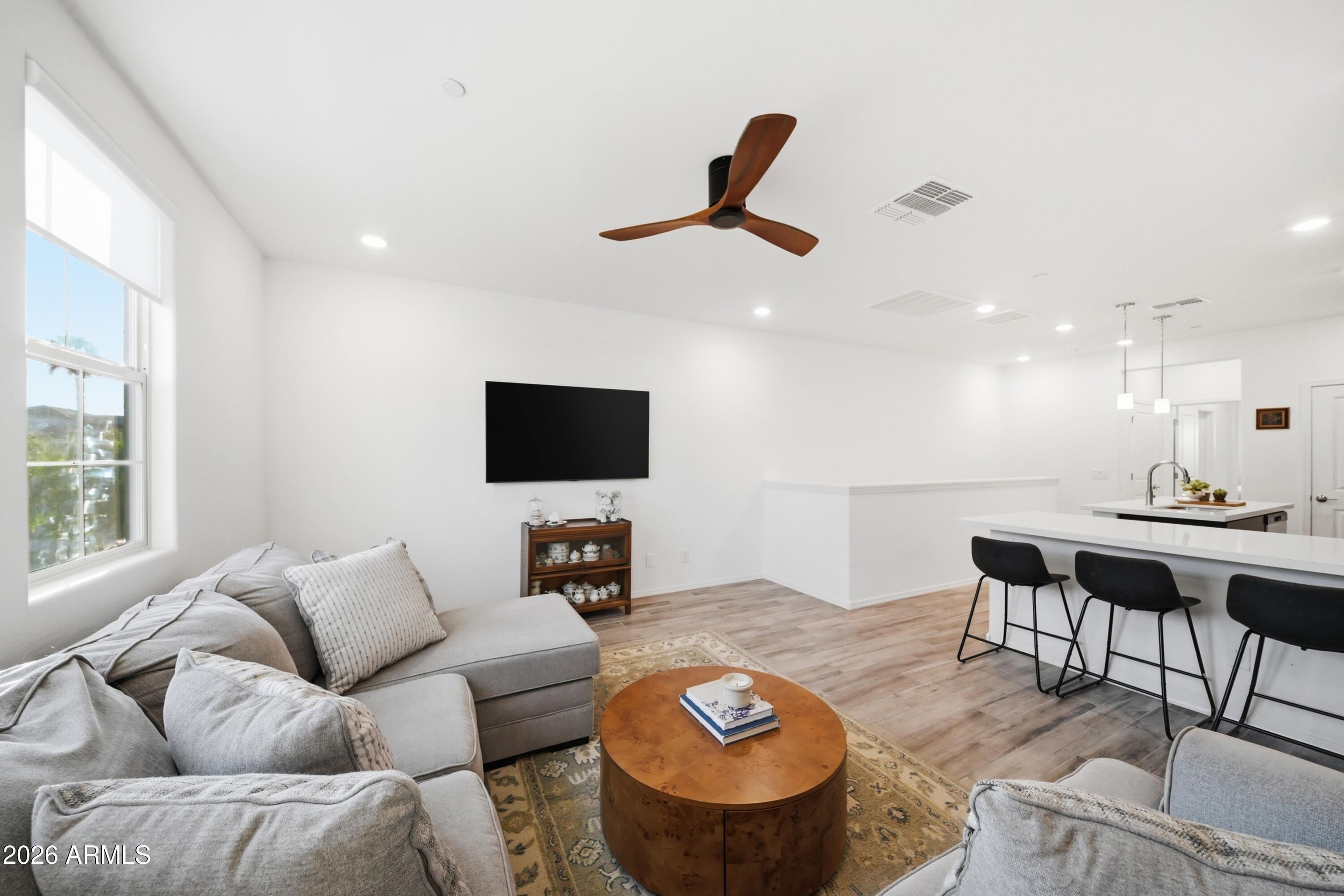 1917 East Hampton Lane, Unit 106 Gilbert, AZ 85295 - Photo 13 of 25 a living room with furniture and a flat screen tv