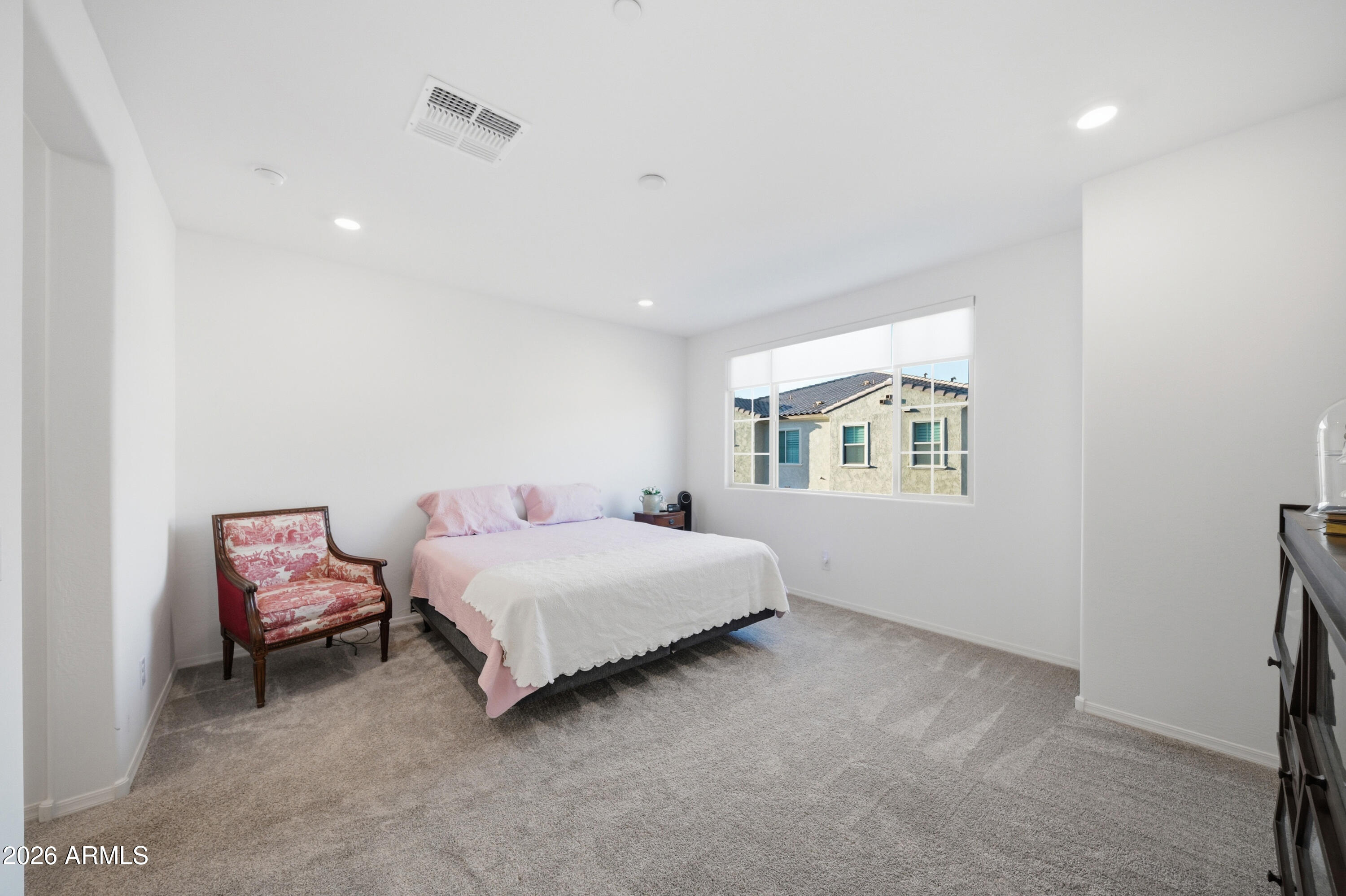 1917 East Hampton Lane, Unit 106 Gilbert, AZ 85295 - Photo 15 of 25 a bedroom with a bed and a window
