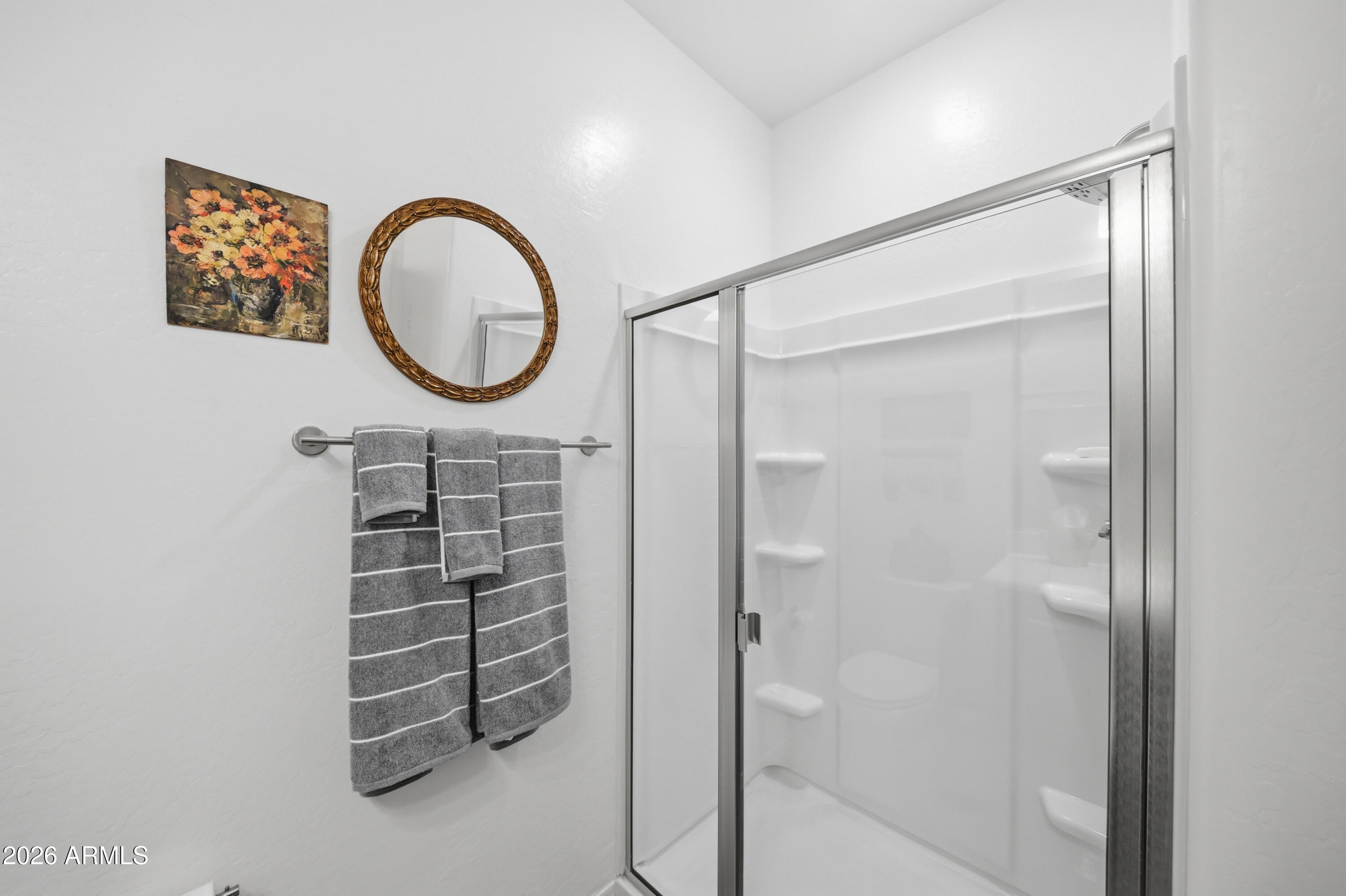 1917 East Hampton Lane, Unit 106 Gilbert, AZ 85295 - Photo 19 of 25 a bathroom with a shower a mirror and a sink