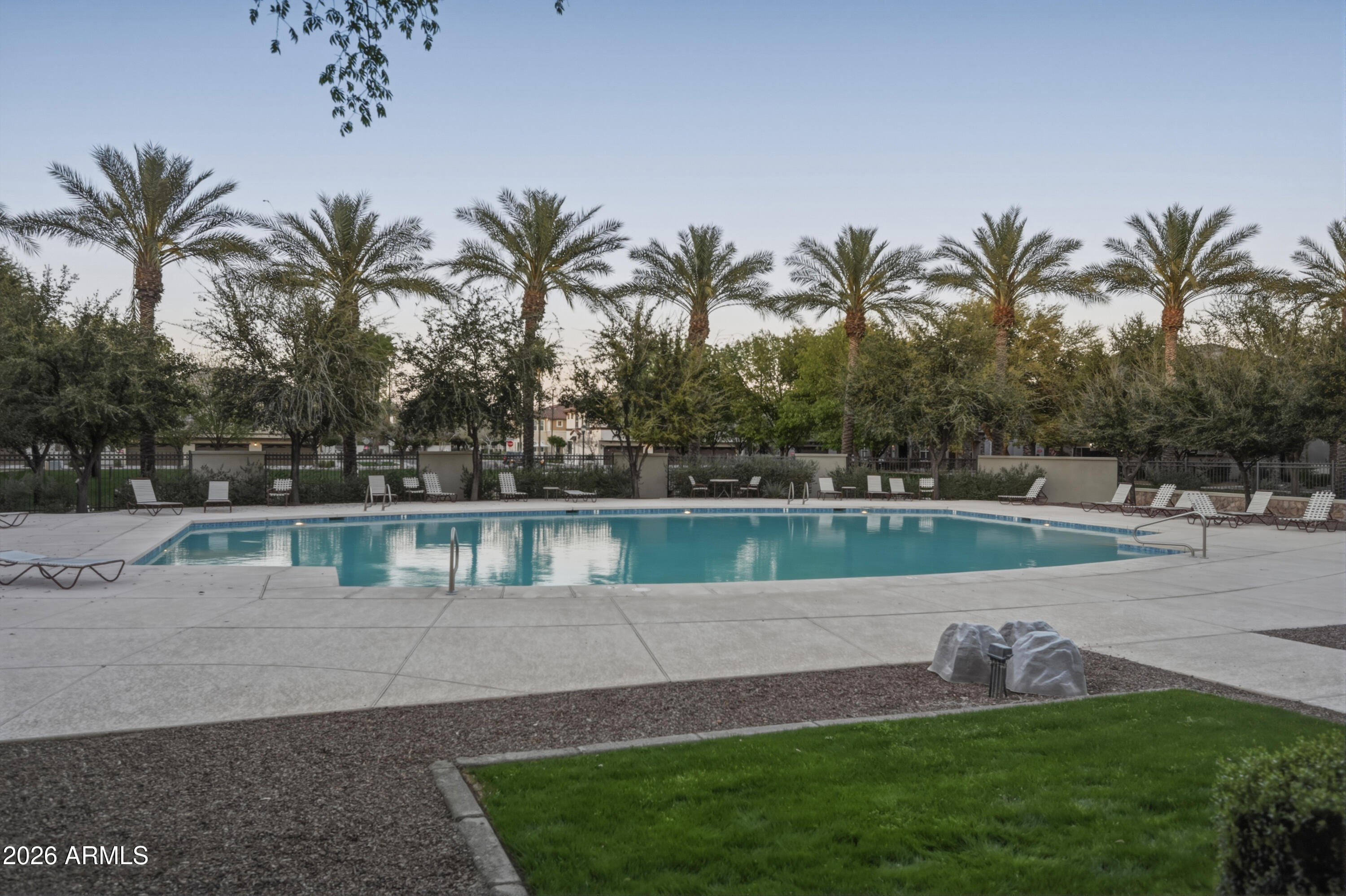 1917 East Hampton Lane, Unit 106 Gilbert, AZ 85295 - Photo 2 of 25 a swimming pool with green space