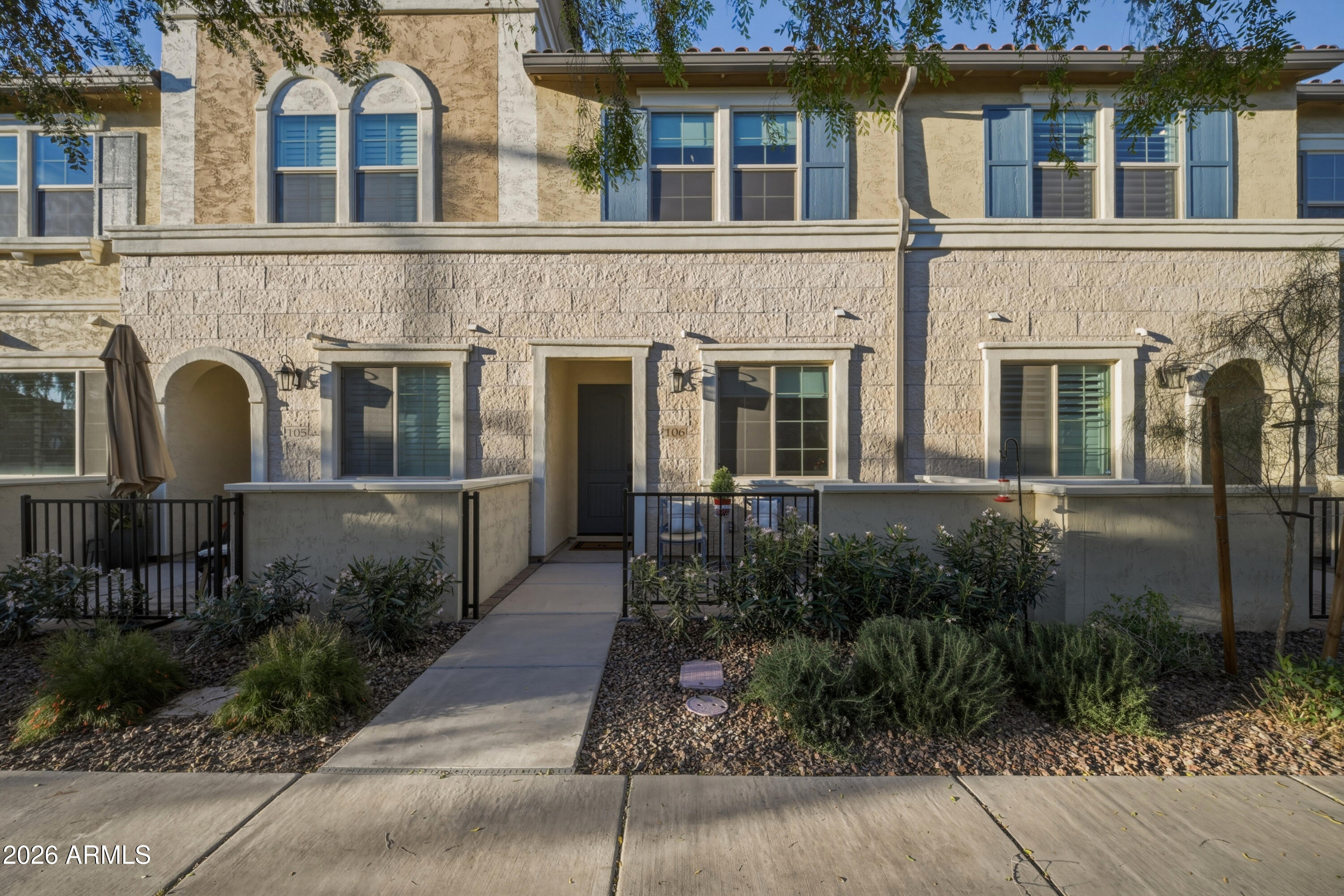 1917 East Hampton Lane, Unit 106 Gilbert, AZ 85295 - Photo 25 of 25 a front view of a house with garden