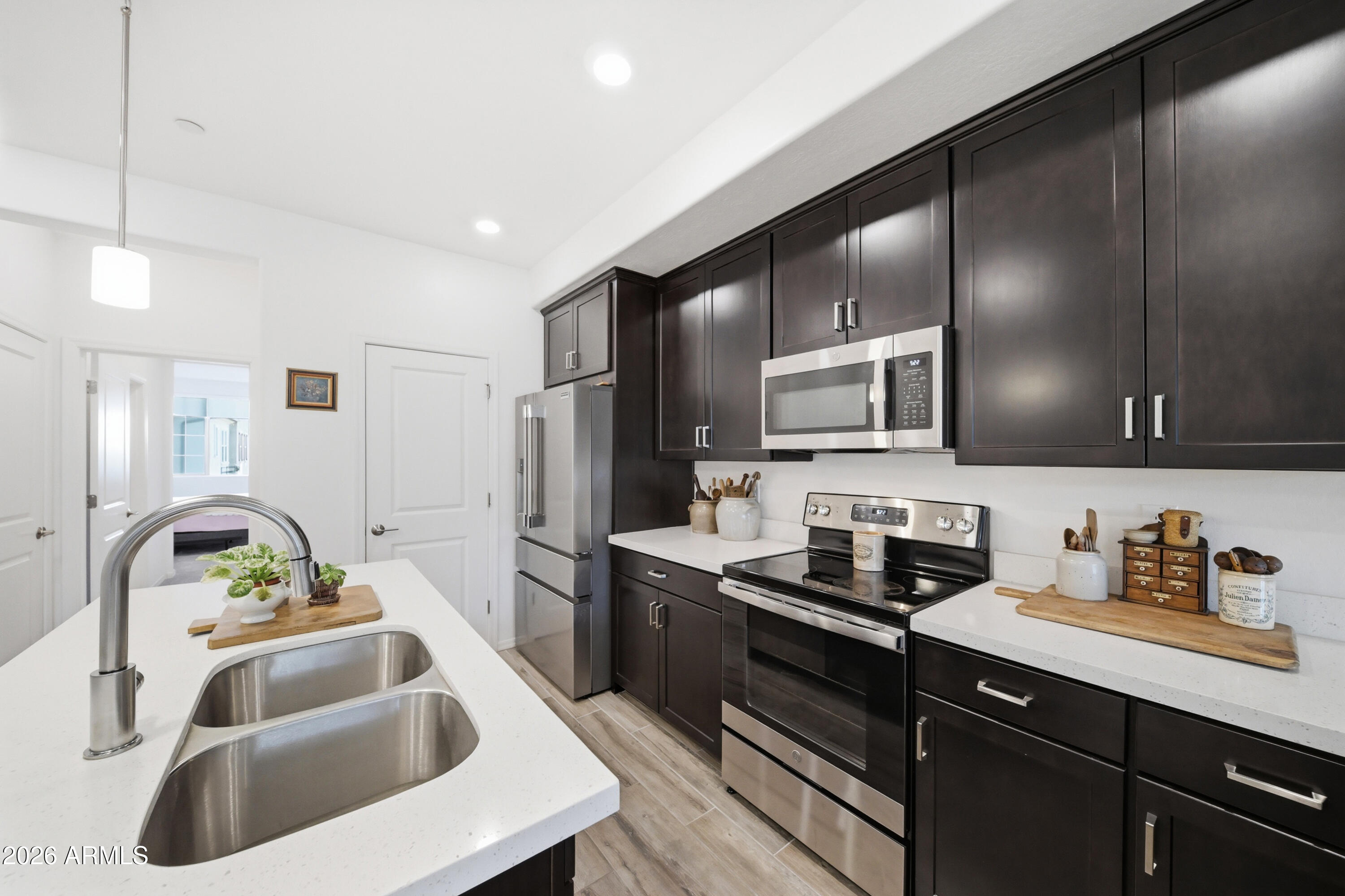 1917 East Hampton Lane, Unit 106 Gilbert, AZ 85295 - Photo 10 of 25 a kitchen that has a sink and cabinets