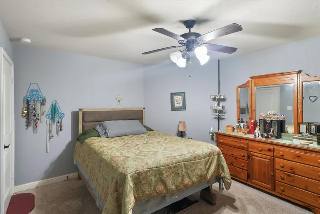 a bedroom with a large bed and a chandelier