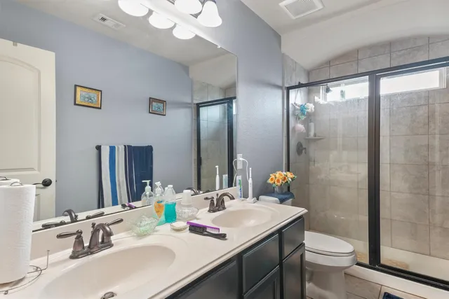 a bathroom with a sink toilet and shower