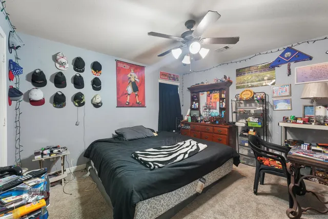 a bed room with a bed and a chair