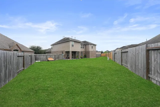 a view of a house with backyard and porch