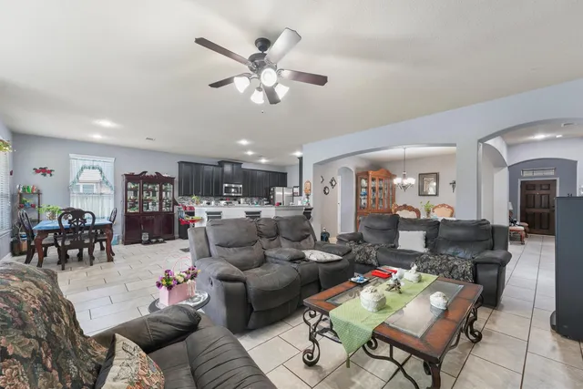 a living room with furniture and kitchen view