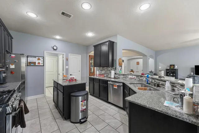 a kitchen with kitchen island granite countertop lots of counter top space