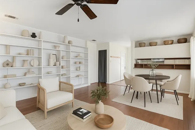 a living room with furniture and a dining table with kitchen view