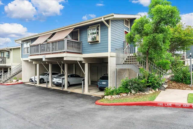 a view of a house with a yard and sitting area