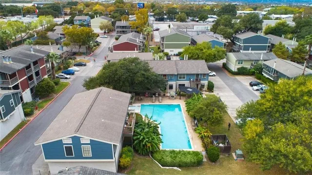 an aerial view of multiple houses with yard