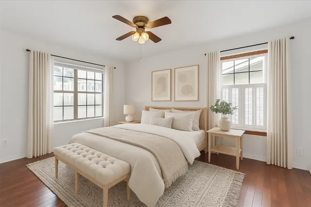 a bedroom with a bed a chandelier and a window