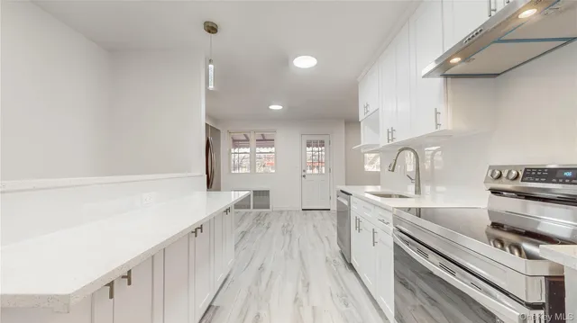 a kitchen with a sink stove and cabinets