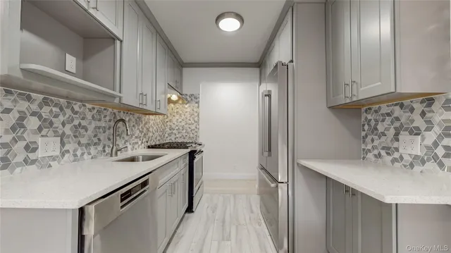 a kitchen with a sink and a refrigerator