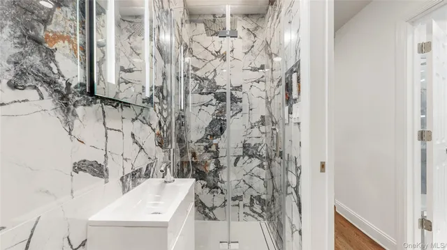 a bathroom with a shower and a sink