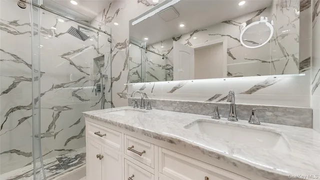 a bathroom with a sink vanity granite and a mirror