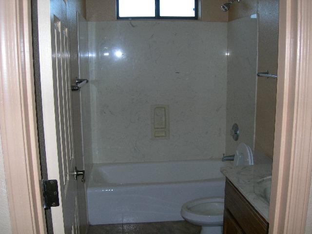980 North Hilton Road Apache Junction, AZ 85119 - Photo 10 of 12 a bathroom with a granite countertop sink a toilet and shower
